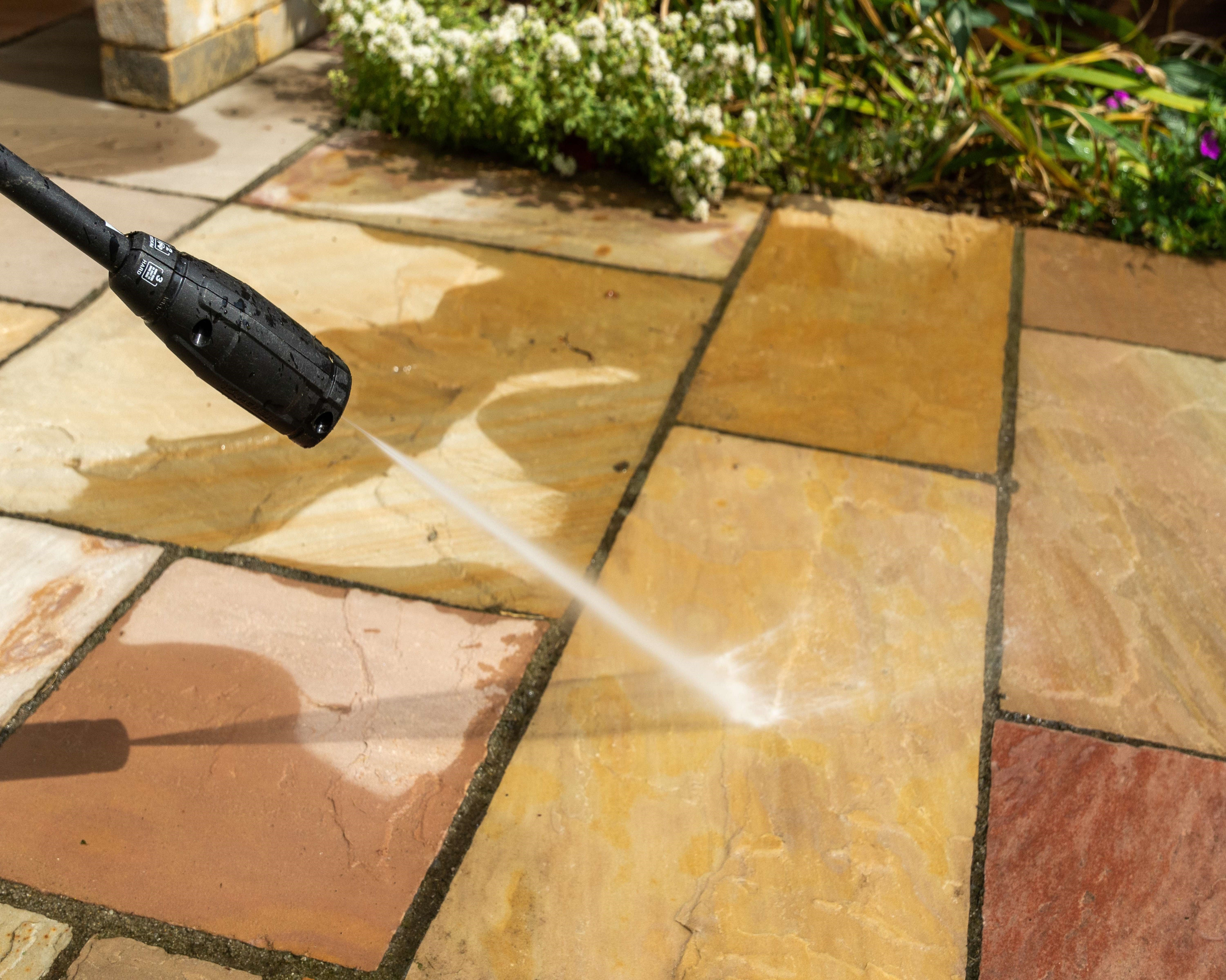 Pressure washer cleaning UK garden paving slabs